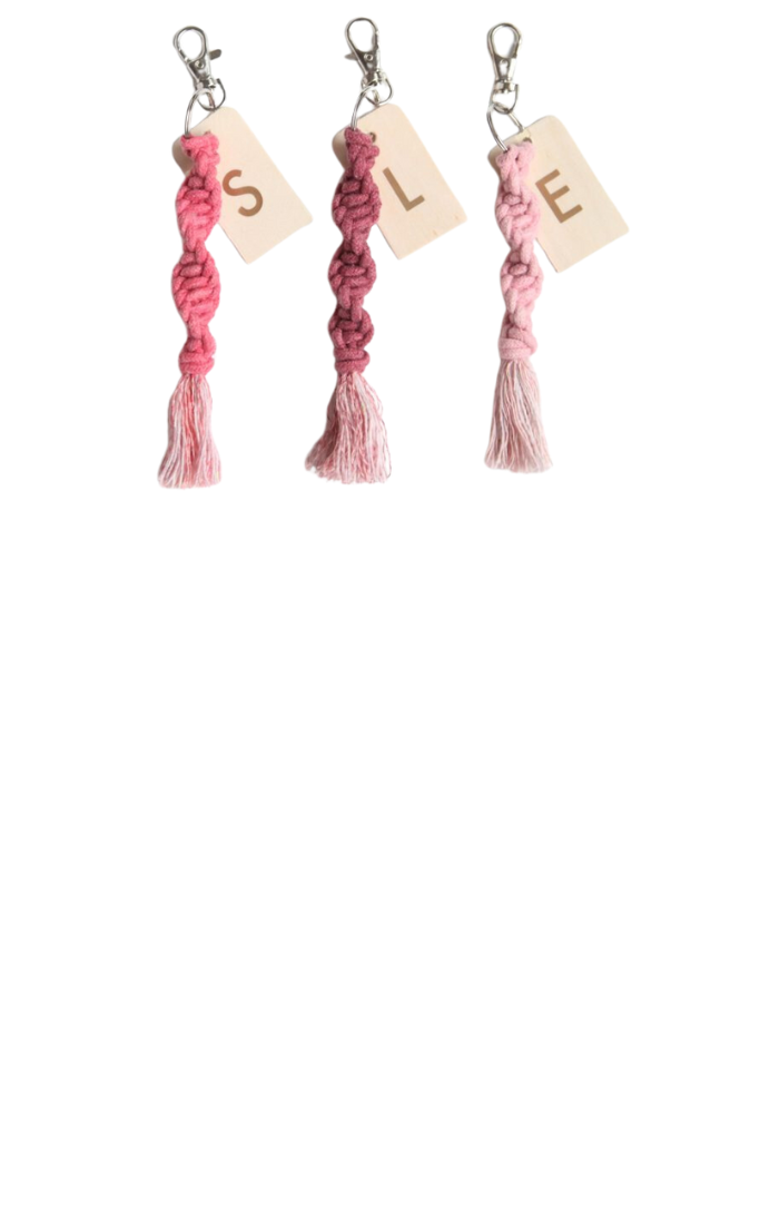 pink macrame keychains on a white background