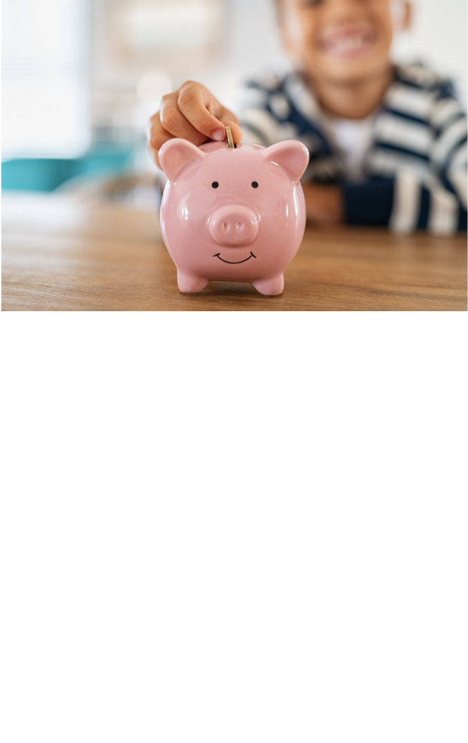 pink piggy bank on brown table with unfocused child smiling in the background